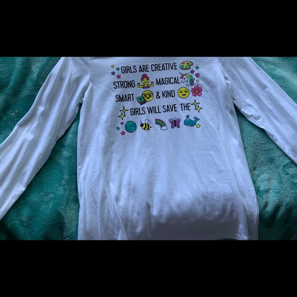 This is a white long sleeve shirt writing on front